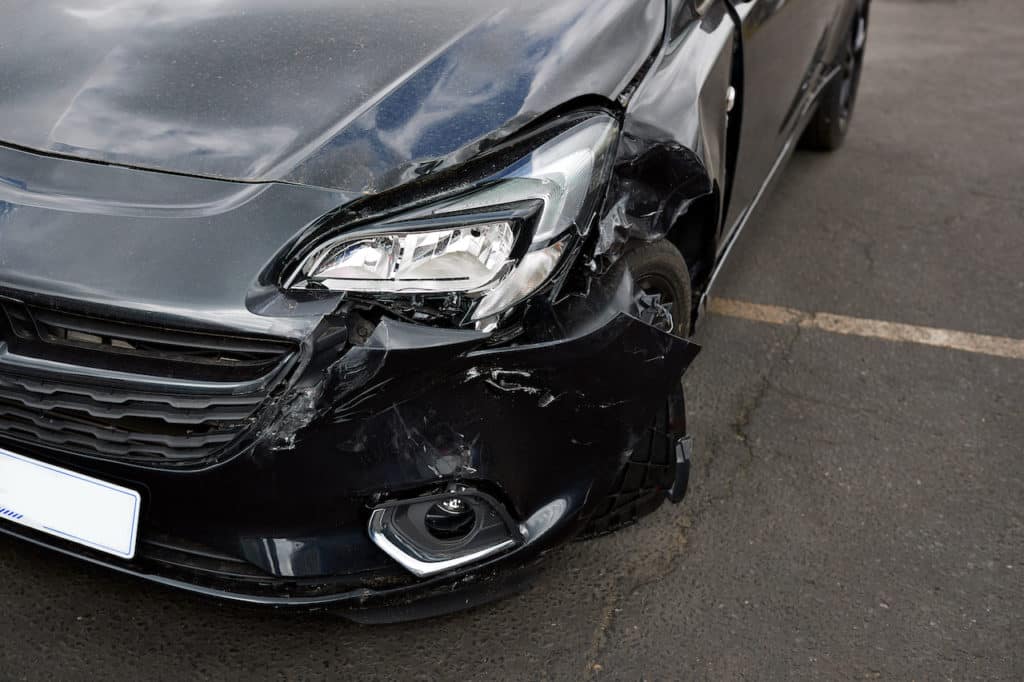 car with a dented bumper from a collision
