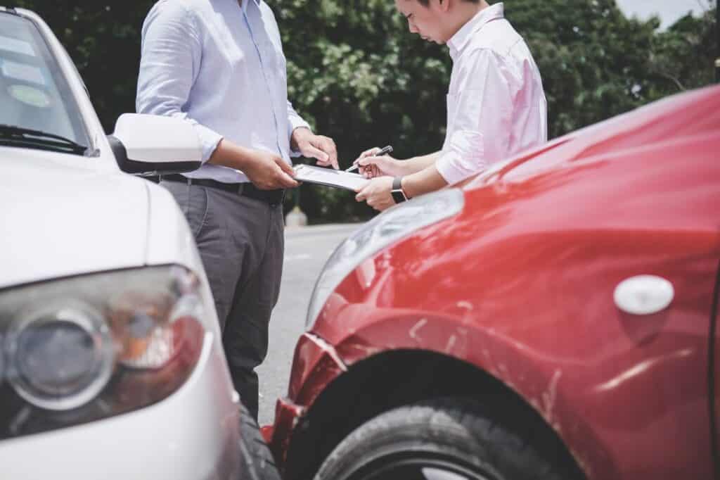 insurance agent examine damage car after accident