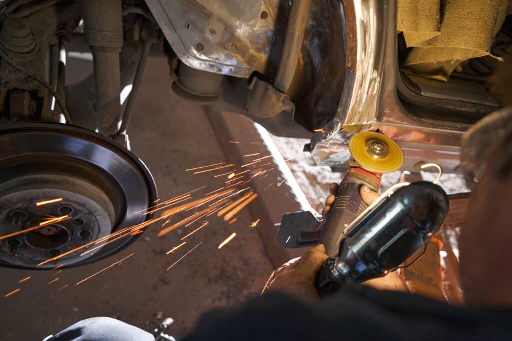 Person works on collision repair