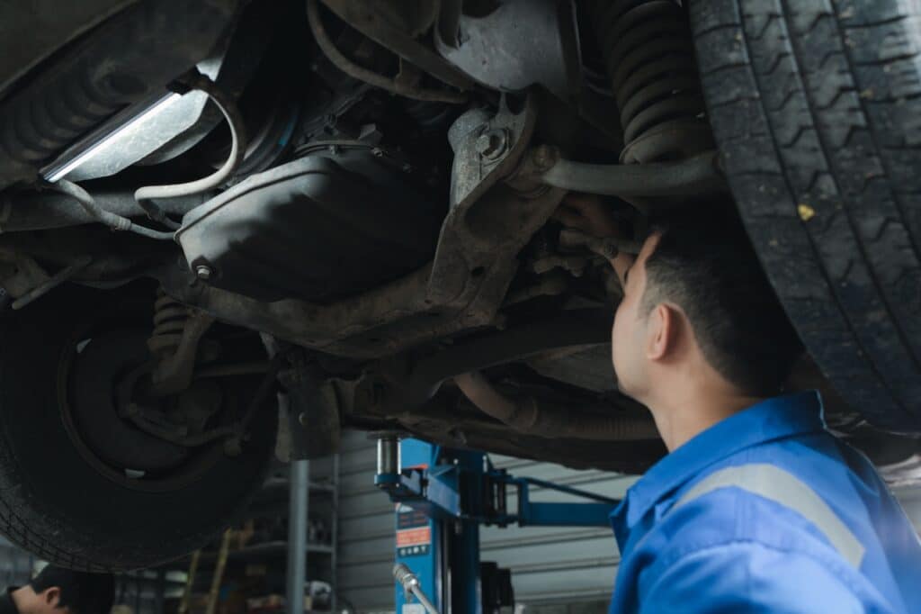 mechanic repairing undercarriage damage