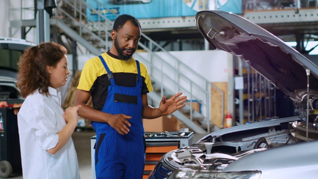 woman asking collision repair shop some frame repair questions